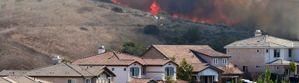 Fires burning behind homes