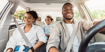 family driving in their new car