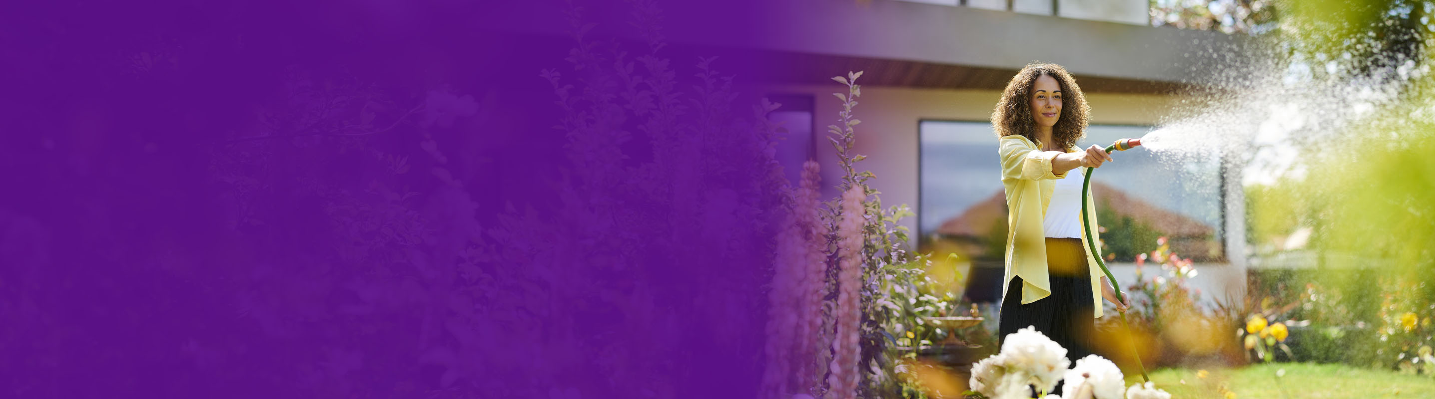 women watering the flower bed