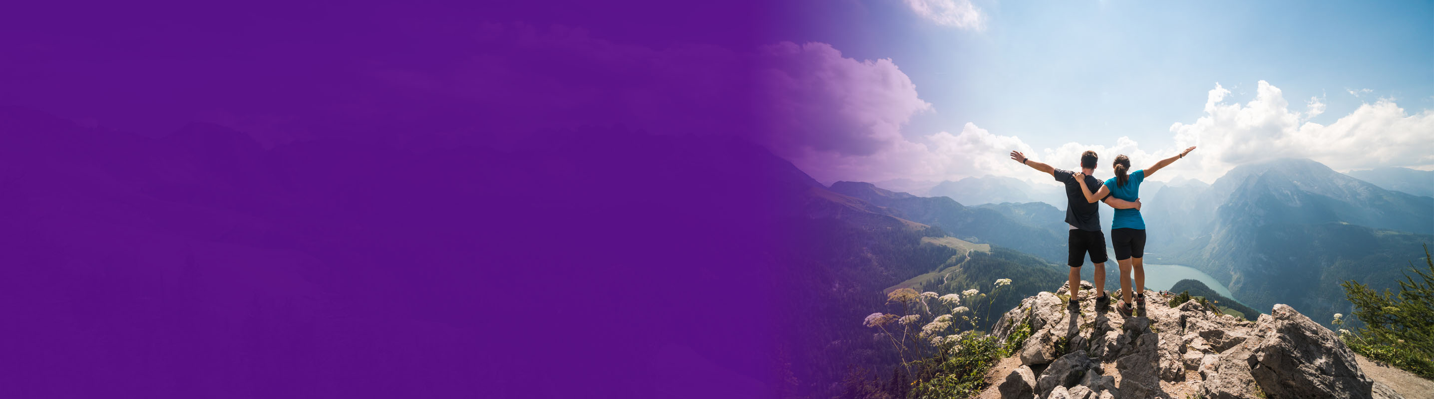 women couple standing on a hill top overlooking a valleystanding on a hill top overlooking a valley