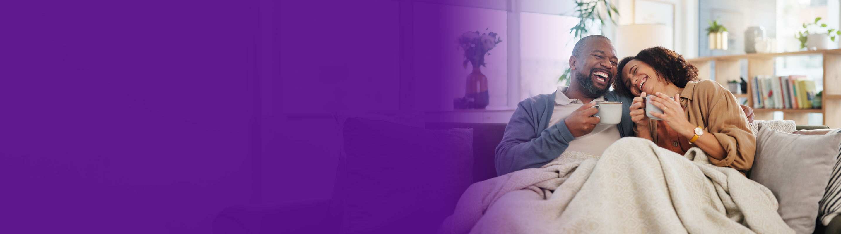 couple having coffee on their sofa