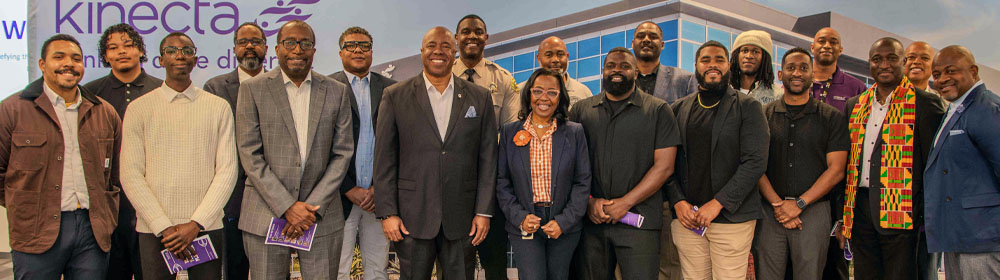 Attendees of the event stand for a group picture.