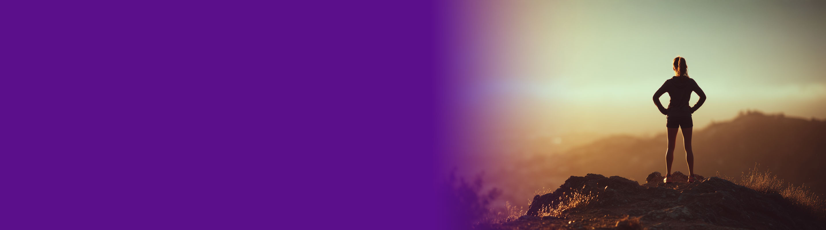 women standing on a hill top overlooking a valley