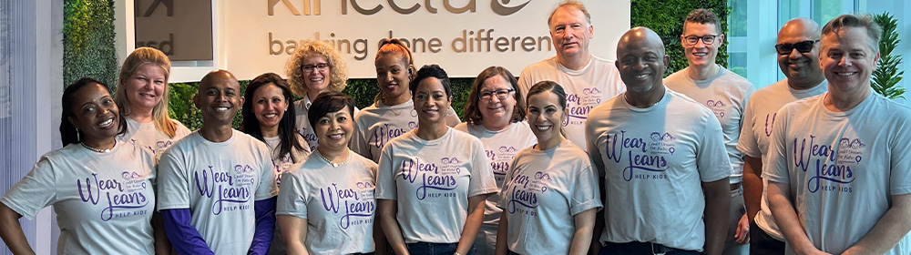 Kinecta employees stand for a picture during Miracle Jeans Month.